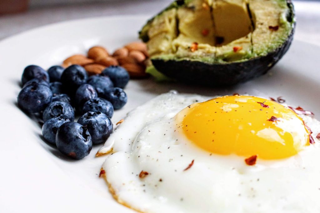 Piatto con uovo, avocado, mirtilli e mandorle – dieta chetogenica